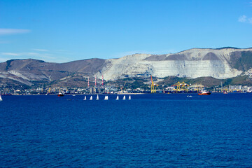 Many small yachts against the backdrop of mountains. City Novorossiysk, Russia. Blue Sea