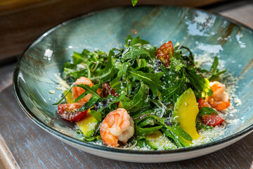 salad with shrimp, avocado, fresh vegetables and herbs, served with white wine