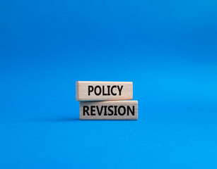 Policy revision symbol. Concept word Policy revision on wooden blocks. Beautiful blue background. Business and Policy revision concept. Copy space