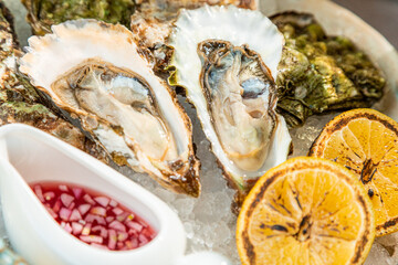 open and closed oyster with sauce and lemon