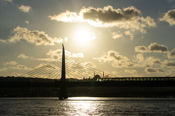 Obraz premium Sunset in Istanbul with bridge and clouds