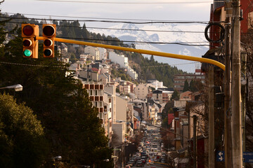green traffic light in the city of bariloche with mountains in the background