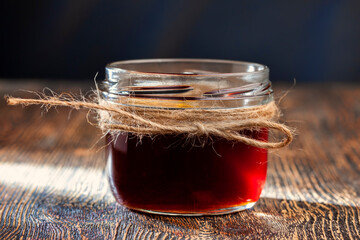 Sweet bee honey in a transparent glass jar