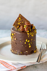 Chocolate cake. Pistachio and chocolate cake on gray background. close up