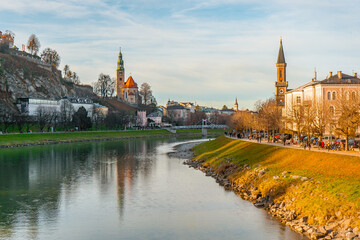Fototapeta premium Panoramic and Mulln Church along Salzach river near Marko Feingold Steg , Hohensalzburg during autumn , winter : Salzburg , Austria : December 9 , 2019