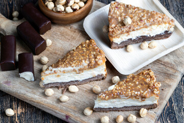 A piece of cheesecake cake with roasted peanuts in caramel