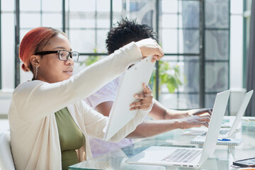 Businesswomen meet to discuss document in office