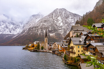 Panoramic classic view at Hallstatt , Unesco Romance town at Lake Hallstatt and Salzkammergut  during winter cloudy day : Hallstatt , Austria : December 10 , 2019