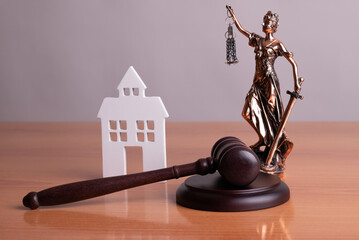 Lady Justice, Judge gavel and house. Concept of real estate auction or dividing house when divorce,...
