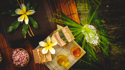 Spa and Wellness Treatment Decorations accessories Inspirations with herbal, sponge scrub, aroma candles, plumeria frangipani flowers, and towels, for body and skin care therapy and relaxation