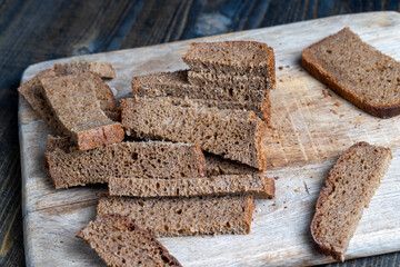 sliced rye bread on a wooden table, close up