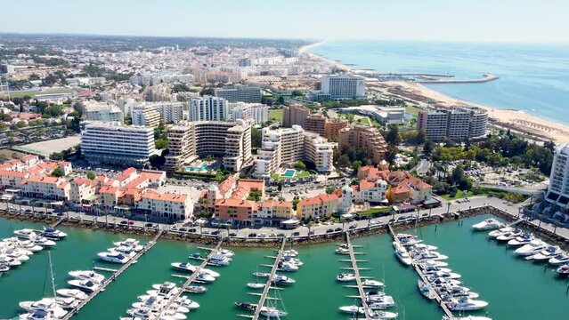 Vilamoura, PORTUGAL: September 18 2022:. Beautiful aerial perspective of Vilamoura marina. Luxury urbanisations, yachts docked in the port. Famous travel destination in Algarve, south of Portugal