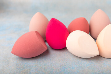 Beauty blender.Colorful beauty sponges on blue background. Cosmetic tool for applying and blending products such as foundation and concealer. Copy space. place for text.