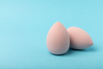 Beauty blender.Colorful beauty sponges on blue background. Cosmetic tool for applying and blending products such as foundation and concealer. Copy space. place for text.