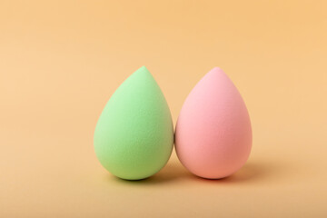 Beauty blender.Colorful beauty sponges on a beige background. Cosmetic tool for applying and blending products such as foundation and concealer. Copy space. place for text.