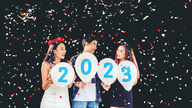 2023 Newyear party ,celebration party group of asian young people holding balloon numbers 2020 happy and funny concept