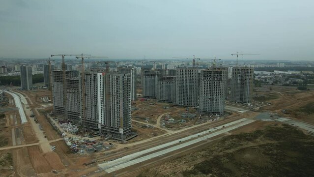 Modern urban architecture. Multi-storey buildings with infrastructure. Construction site of a new city block. Overcast weather. Aerial photography.