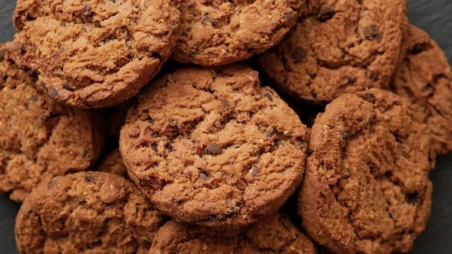Fresh oatmeal cookies rotating. Food concept. Homemade cookies with chocolate. Stack of whole meal cookies. Close-up in 4K, UHD