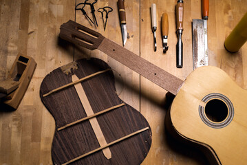 Dark still life of luthier's workshop table.
