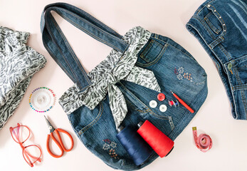 Denim bag with sewing accessories. top view, crafting with denim , recycling concept