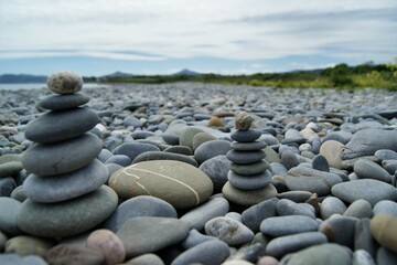 Zen towers on a rocky beach.