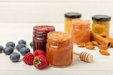 Honey in a glass jar. Raspberry and blueberry honey jam. Remedy for colds and respiratory diseases. Organic product of a vegetarian diet. copy space. copy space
