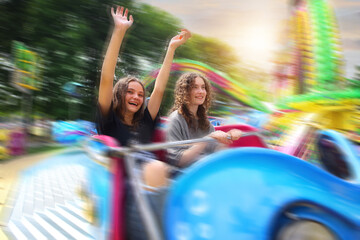 friends are having fun at an amusement park - 532966214