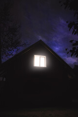 View of the night house and the lit window - 532966230