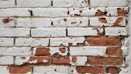 Red brick wall painted white Some colors have come off.