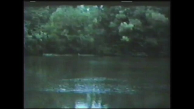1960s: Details of a small dam on a river. Vintage Video