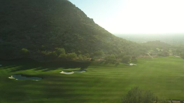 Scottsdale, Arizona golf course and mountains aerial at sunset