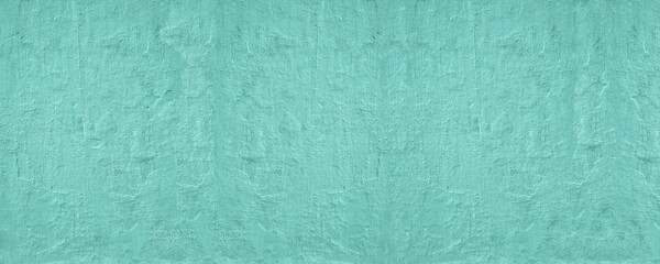 Teal painted old rough concrete wall texture. Turquoise color rough cement plaster surface. Grunge wide background