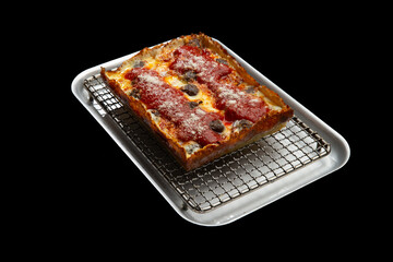 Detroit pizza with meat and sauce on an iron tray