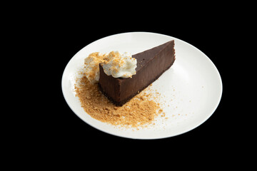 Chocolate dessert in a plate on a black background.