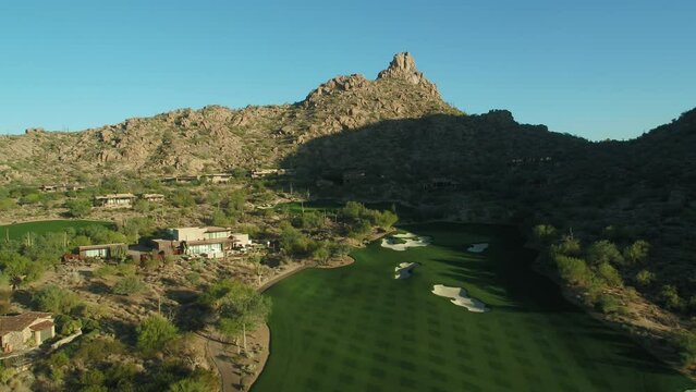 Scottsdale golf course and mountains aerial at sunset front lit with Pinnacle Peak in background