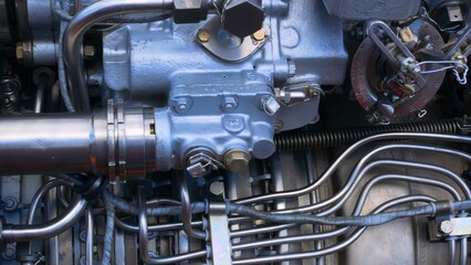 Stainless steel piping to supply fuel and lubricant to the engine. Engine close-up with tubes and...