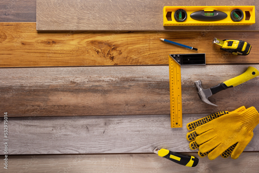 Poster wood laminate and tools on floor background texture. wooden laminate