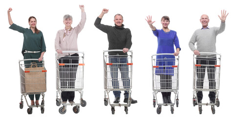group of people with shopping cart showing thumbs up at camera