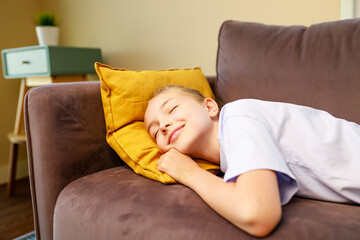 little cute girl sleeping on sofa after study in school daytime