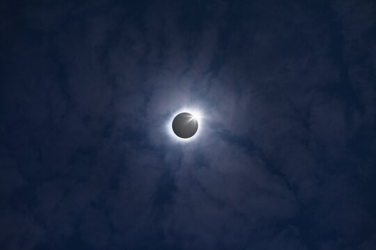 Total solar eclipse in dark blue sky