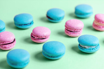 Fototapeta na wymiar Close-up of macarons cakes of different colors in pastel color background. Culinary and cooking concept. Tasty colourful macaroons