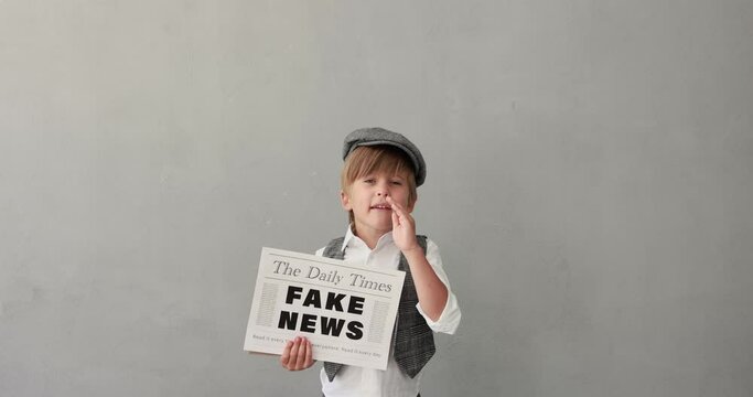 Newsboy shouting against concrete wall background. Boy selling fake news. Child wearing vintage costume. Kid holding newspaper. Slow motion