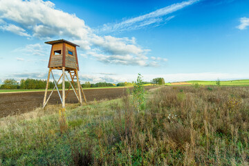 Landscape with hunting lodge in middle of meadow amazing blue sky with clouds