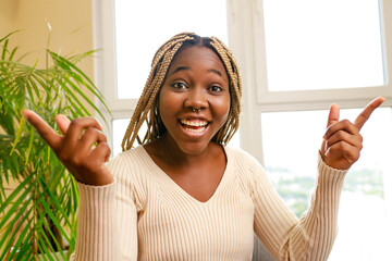 African American woman laughing and telling a funny story in living room an home