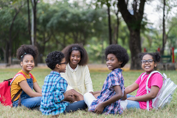 Group of African American children learning outdoor in the park. Diversity black people learning outside the classroom. Kids field trips outside. Kids and educational concept