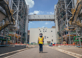 The girl working on the power plant. The photo suitable to use for Industrial poster, background and pamphlet. 