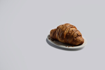 Croissants on a white background top view, space for text,Croissant with chocolate on a white background with copy space