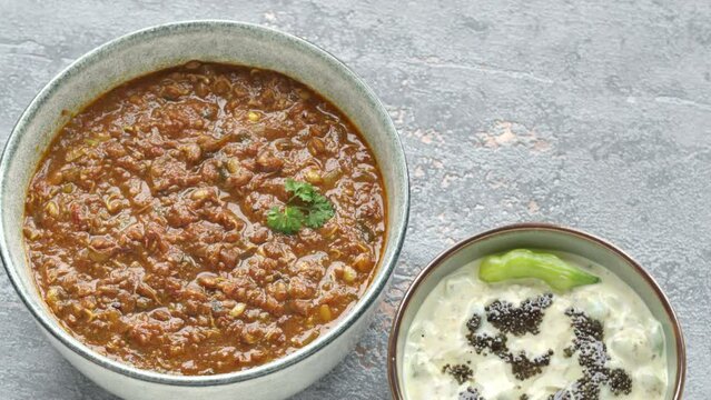 Sprouted Horse Gram Kurma (Korma) and Mogri Raita with black mustard seeds. Table spin.