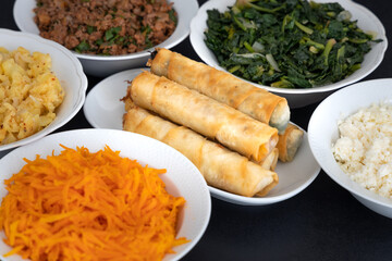 Turkish Cigar Shaped Rolls. Traditional Borek, Burek, cooked, grilled fresh spring rolls food on black background. Copy Space, Top View.