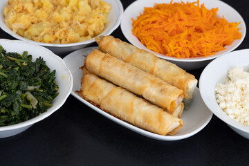 Turkish Cigar Shaped Rolls. Traditional Borek, Burek, cooked, grilled fresh spring rolls food on black background. Copy Space, Top View.